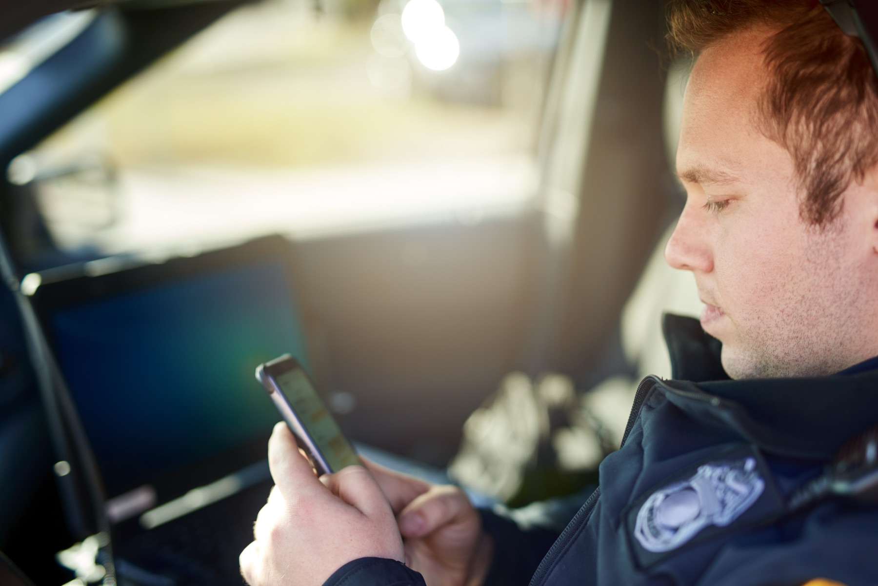 Officer using the new mobile CIT app in a patrol vehicle